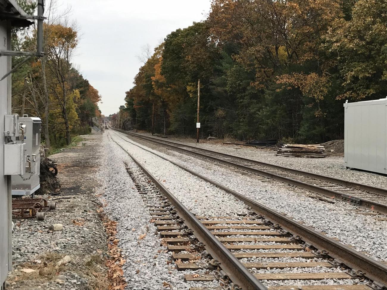 Stone ballast was placed on the tracks before being leveled out by the tamping machine (October 2019)