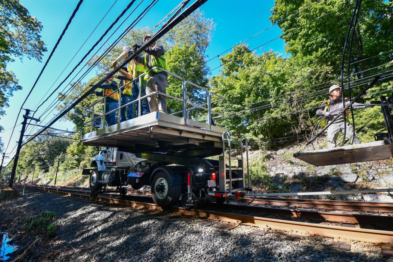 A team of workers install new signal cables near Chestnut Hill on the Green Line D branch.