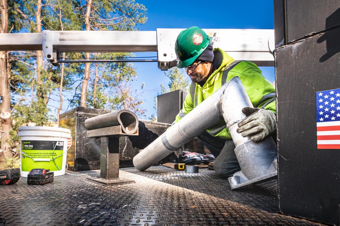 A crew member prepares PTC signal upgrades for installation on the Fitchburg Line of the Commuter Rail (November 2019)