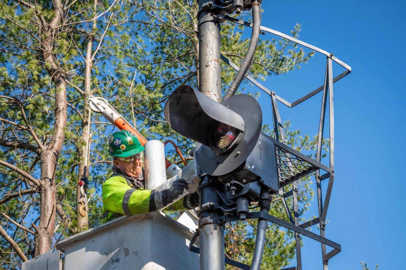 A crew member installs PTC signal upgrades on the Fitchburg Line of the Commuter Rail (November 2019)
