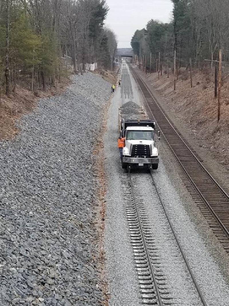 Stone ballast is placed on the tracks as Phase 1 nears completion (February 2020)