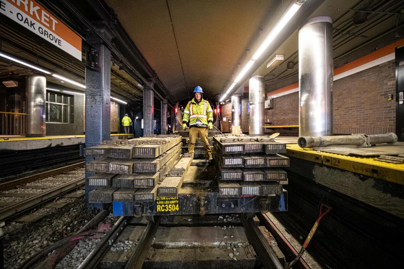 A crew member brings rail ties into Haymarket during the final Orange Line weekend shutdown of winter 2020