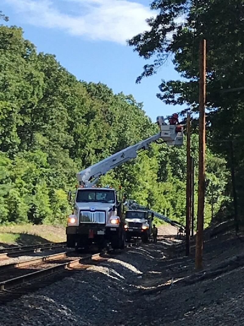 Image of crews installing ATC power poles on Fitchburg Line