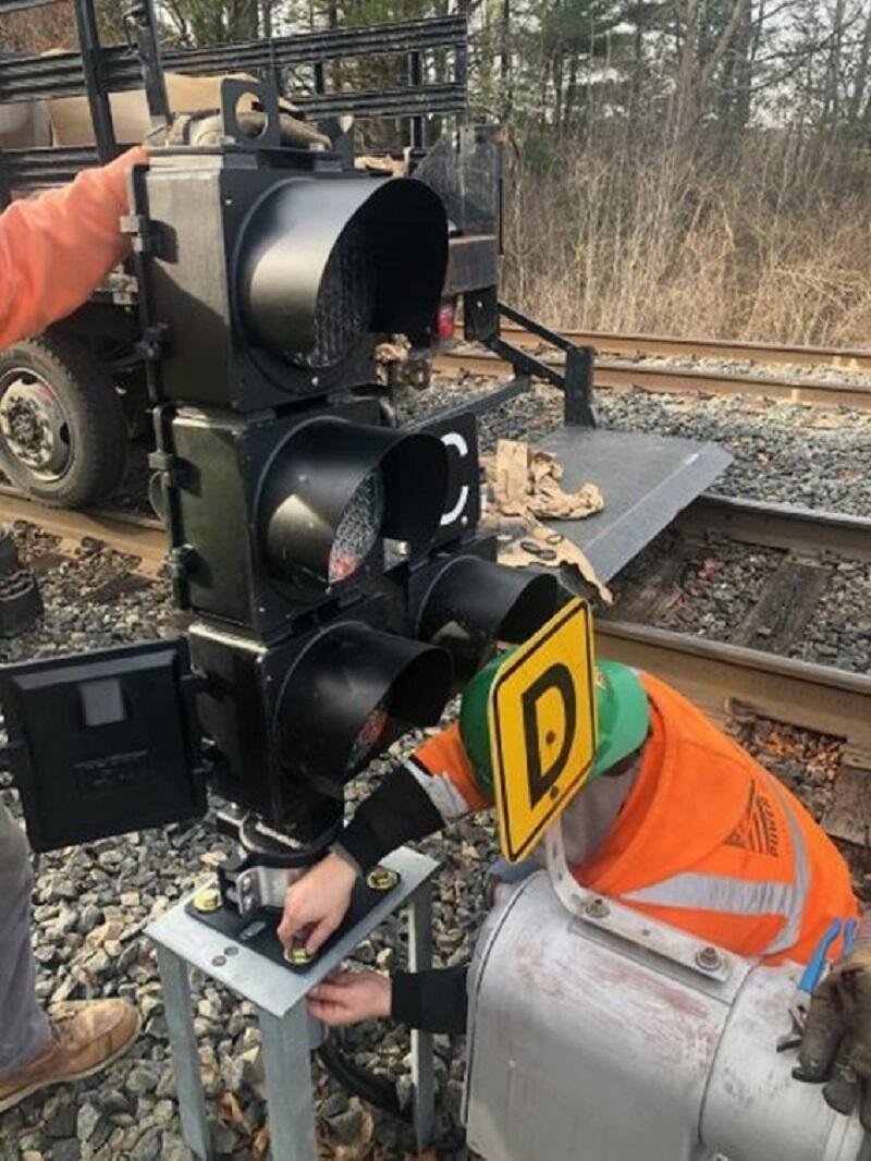 Image of crews installing ATC signal along tracks on Newburyport Line