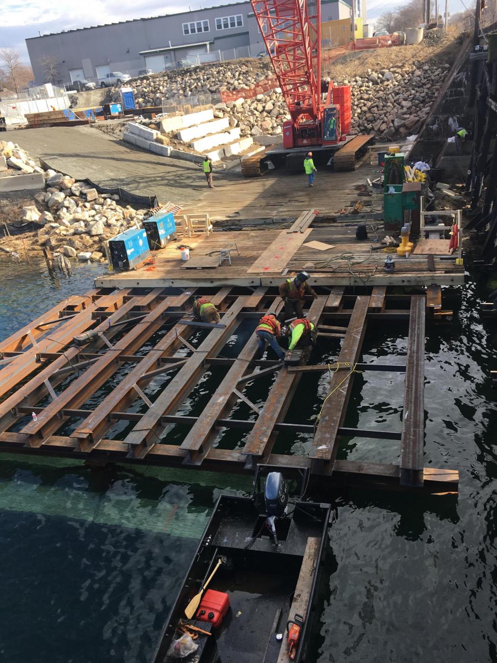 Crew members work to Install a temporary work platform, as part of Gloucester Drawbridge Replacement construction