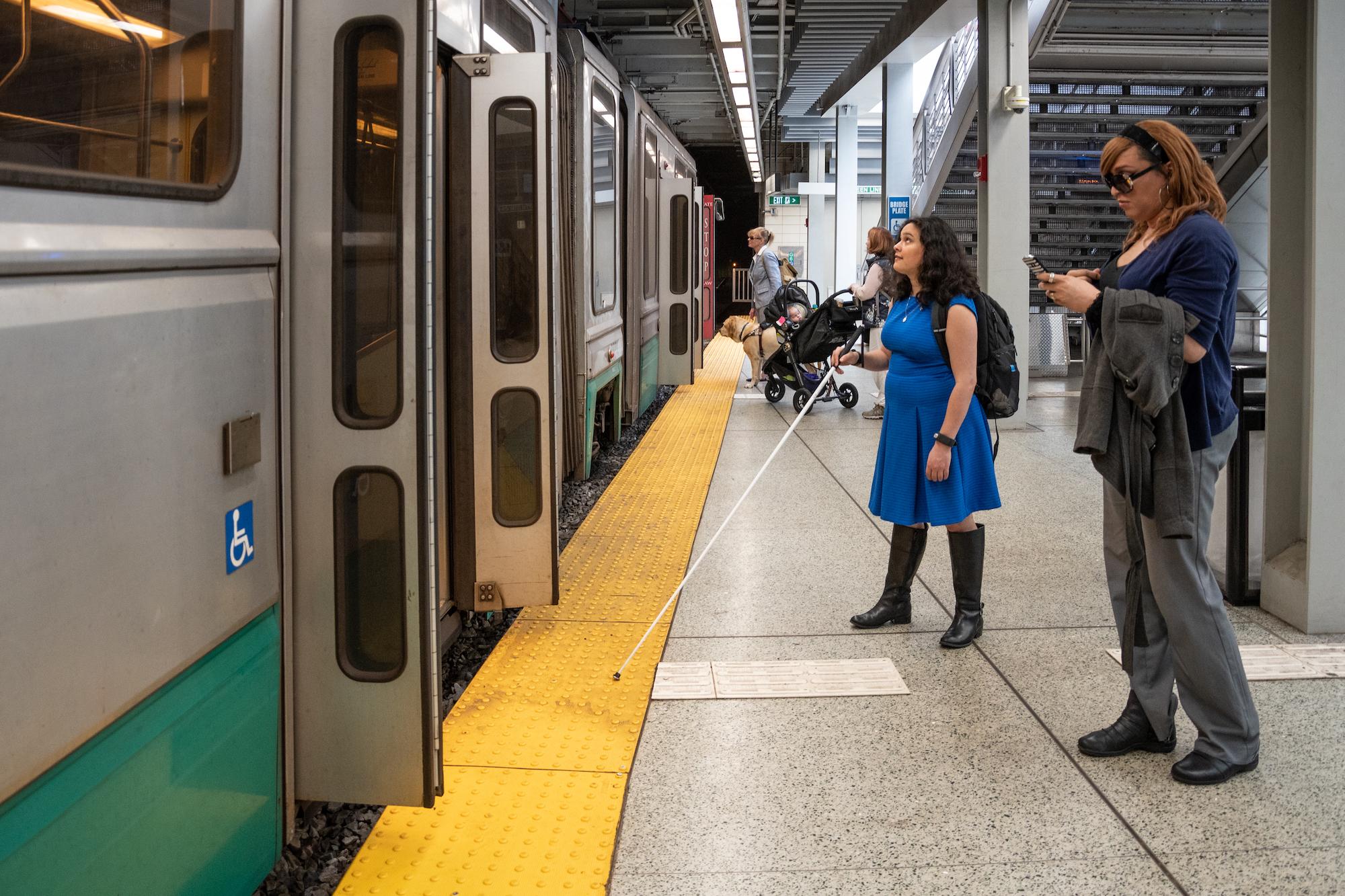 Low-vision rider with a cane at Government Center, about to board a Green Line train
