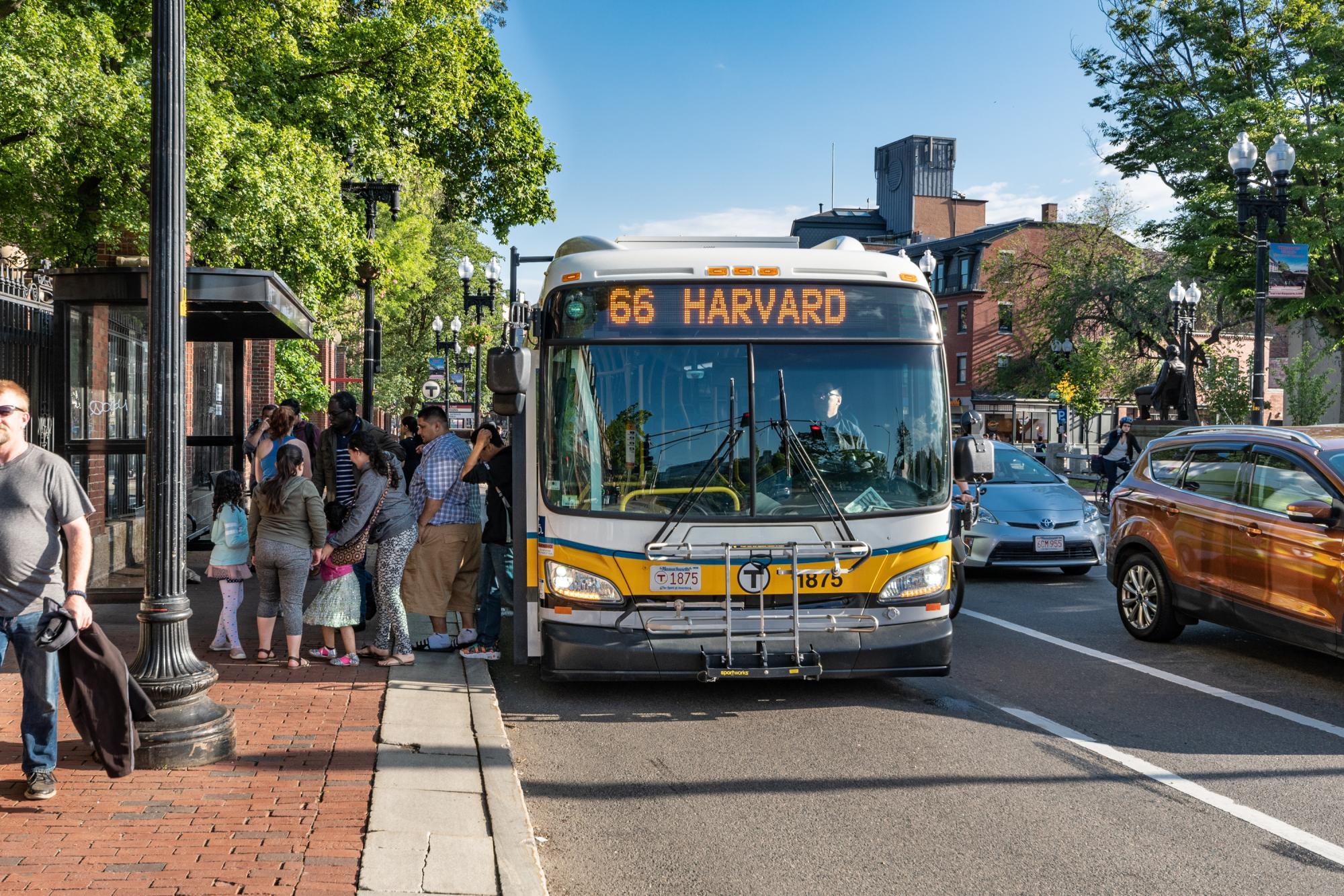 Riders exit a Route 66 bus in Harvard Square
