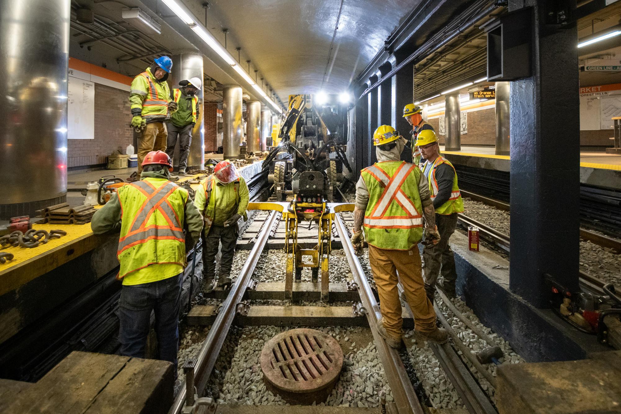 Crew members work on rail tie replacement during the final Orange Line weekend shutdown of winter 2020