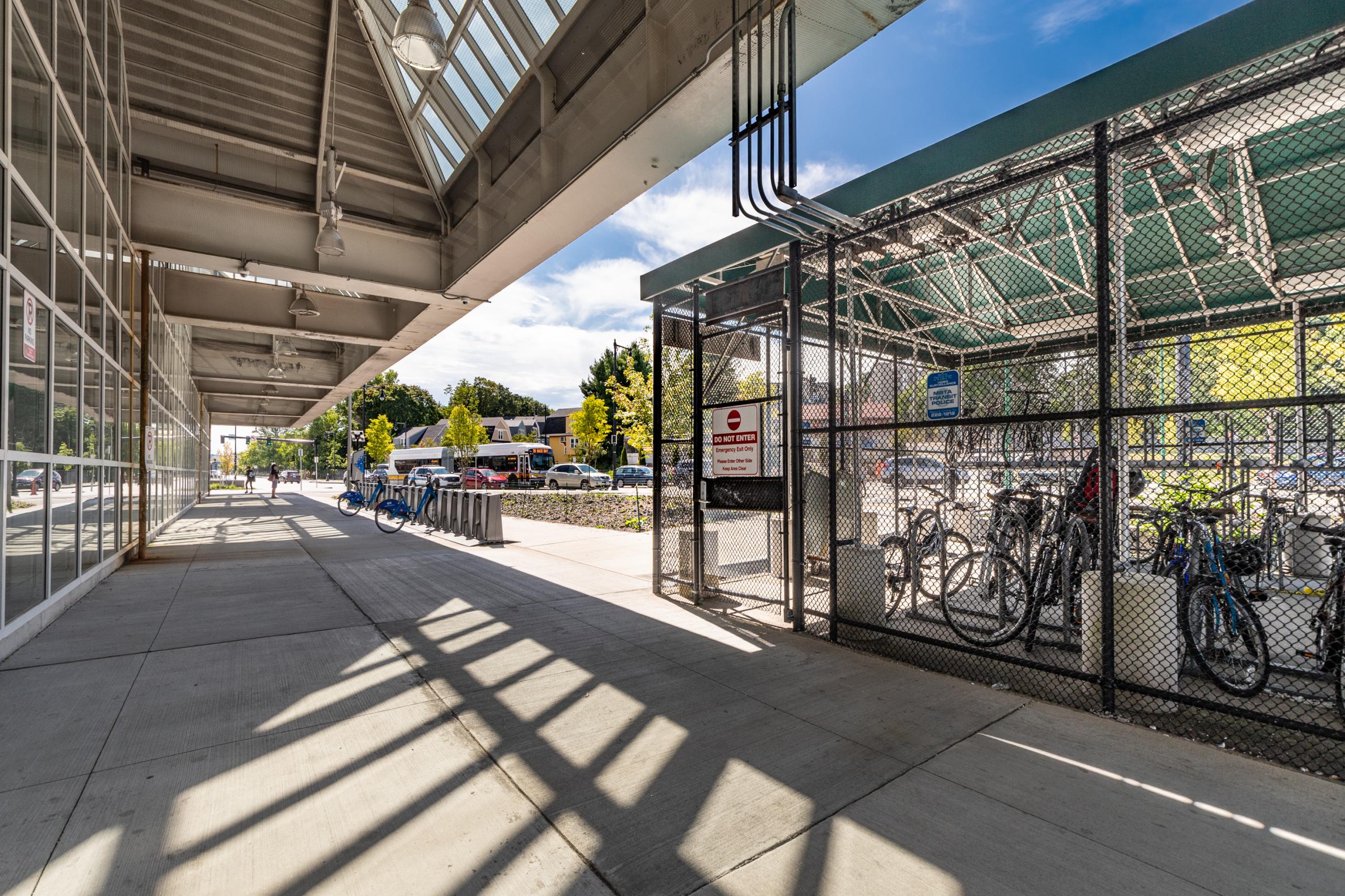 A closed pedal and park bike station with bikes parked inside at Forest Hills station
