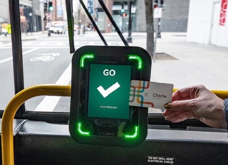 A rider taps the new Charlie Card at one of the CharlieCard reader prototypes installed on bus routes 28 and 39