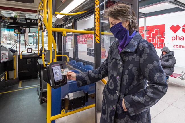 A field demo particpant uses one of the new CharlieCard reader prototypes installed on bus routes 28 and 39