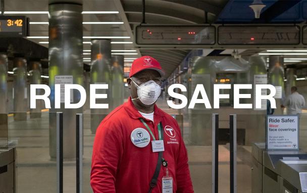 Text overlaid reads "Ride Safer." T Ambassador with a mask stands at the fare gates at Maverick Station.