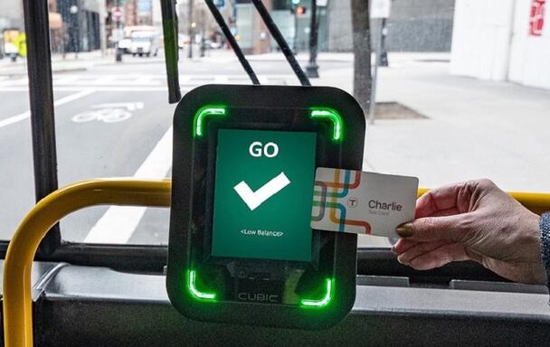 A rider taps the new Charlie Card at one of the CharlieCard reader prototypes installed on bus routes 28 and 39